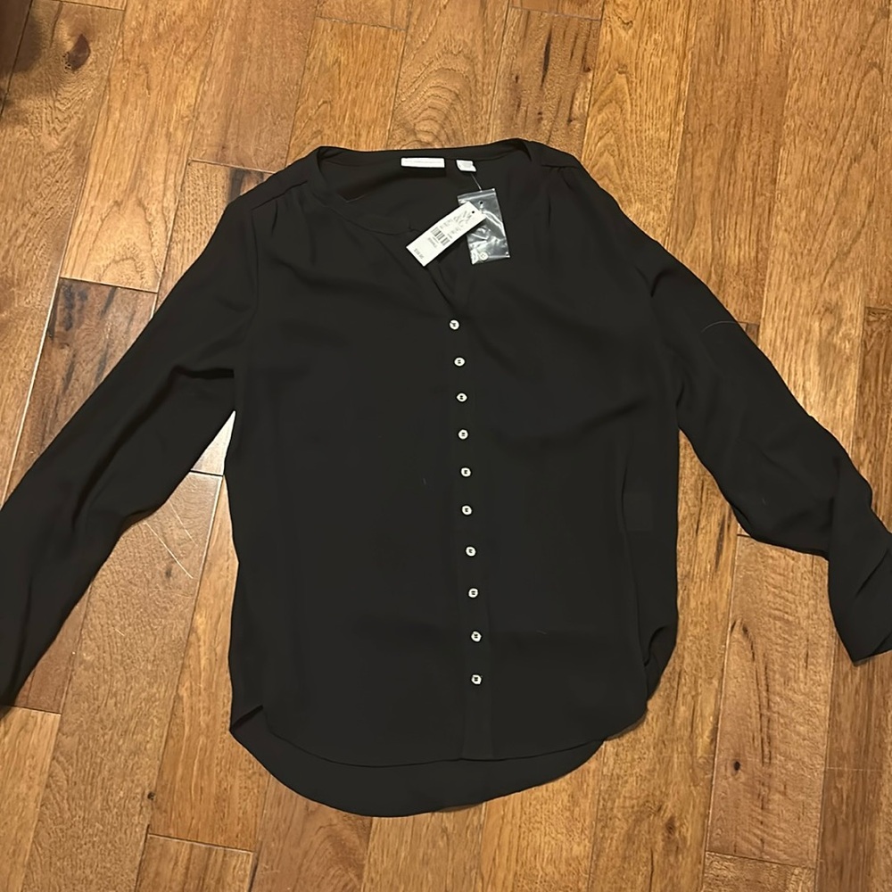 Black button up long sleeve business casual top.